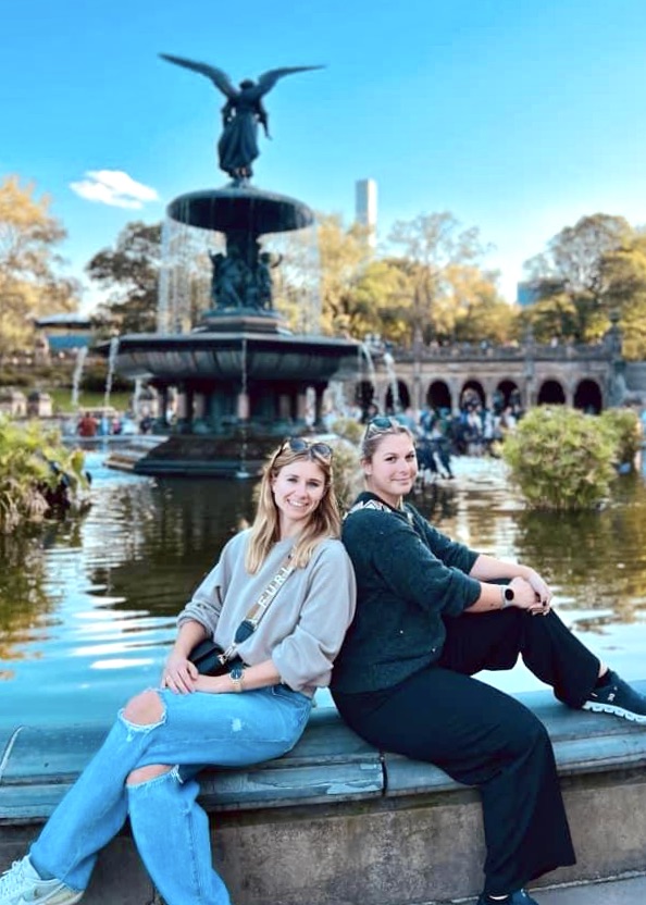 Two women sitting by Bethesda Fountain in Central Park