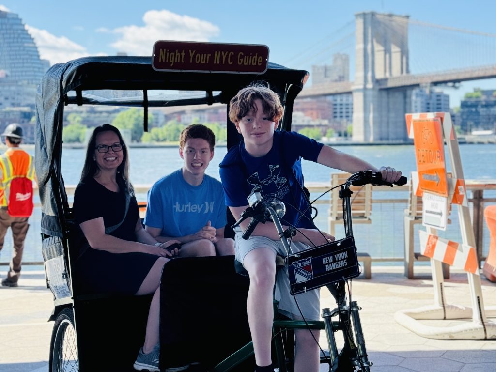boy on pedicab near brooklyn bridge